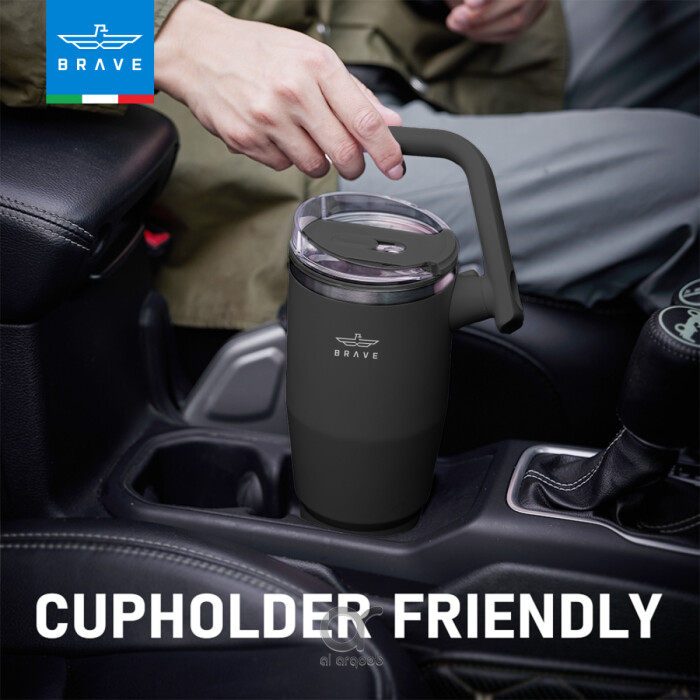 A black Brave Tumbler Mug with a 180° rotating handle is shown fitting neatly into a car’s cup holder. 