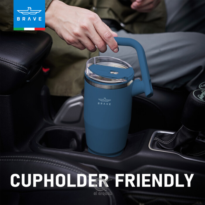 A black Brave Tumbler Mug with a 180° rotating handle is shown fitting neatly into a car’s cup holder.