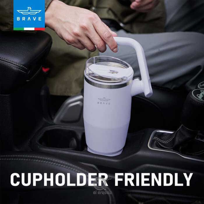 A purple-toned Brave Tumbler Mug with a 180° rotating handle is shown fitting neatly into a car’s cup holder.