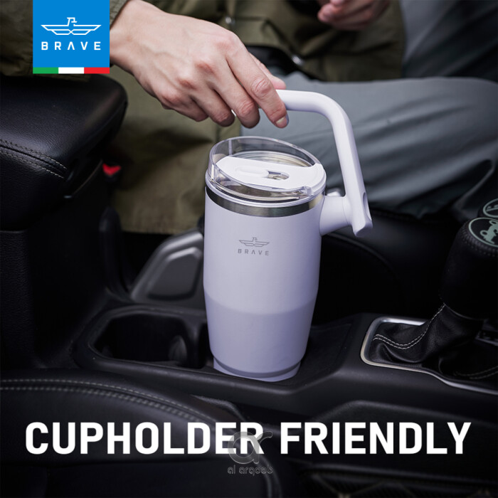 A purple-toned Brave Tumbler Mug with a 180° rotating handle is shown fitting neatly into a car’s cup holder.